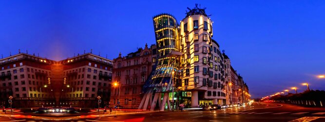 Trip Voucher Reisetipps - Das tanzende Haus ist ein Bürogebäudes in der tschechischen Hauptstadt Prag. Beliebte Aussichtsplattform mit schöner Architektur in Prag. Das „Tanzende Haus“ in Prag, das charismatische Bürogebäude mit dem Namen Ginger & Fred in Tschechien bezaubert mit mutiger Architektur. Geschwungen, dynamisch, strahlt es eine charmante Ungezwungenheit und Fröhlichkeit aus. Oben in der Glas-Bar genießt man den herrlichen Rundblick. Wie eine Tänzerin im Kleid, die sich an einen Herrn mit Hut schmiegt: Und doch ist es ein Haus. Das Tanzhaus ist eines der neuen Denkmäler der Stadt.